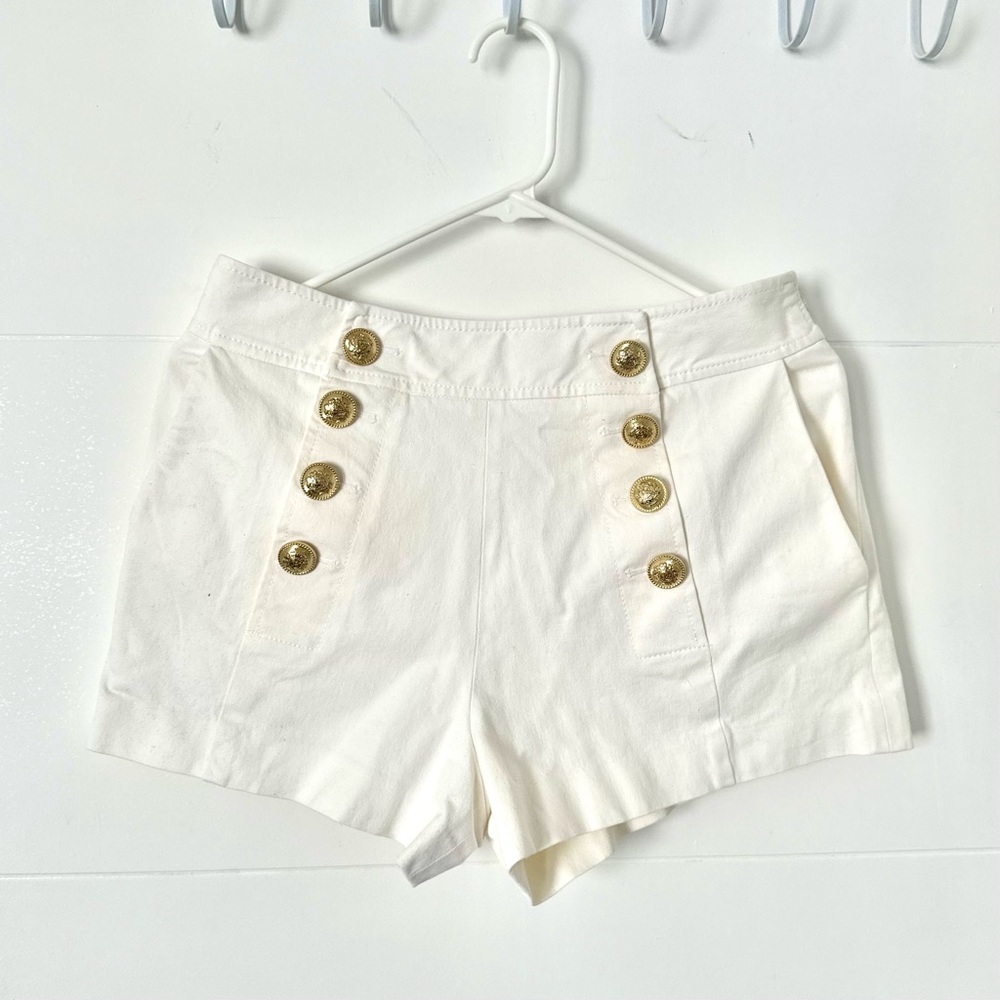 White shorts with gold buttons